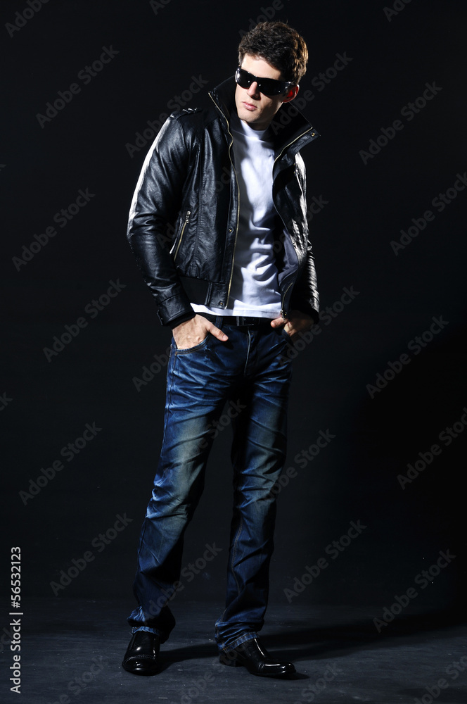 Handsome young businessman in sunglasses. Full body Handsome young businessman in sunglasses. Full body
