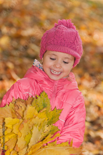 Little girl with yellow leaves