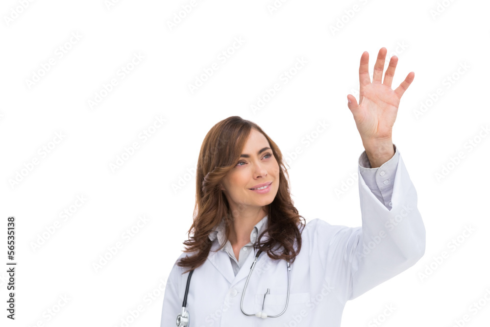 Brunette doctor reaching for something in the air Brunette doctor reaching for something in the air