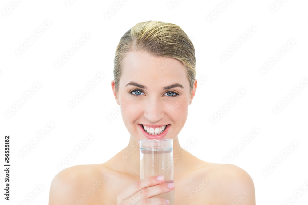 Smiling attractive blonde holding glass of water Smiling attractive blonde holding glass of water