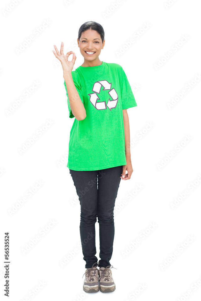 Black haired model wearing recycling tshirt making okay gesture Black haired model wearing recycling tshirt making okay gesture