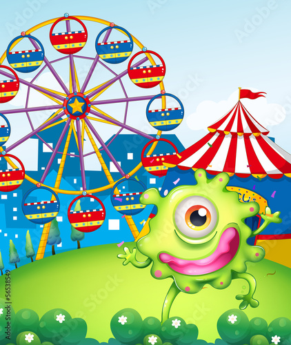 A one-eyed green monster at the carnival in the hilltop