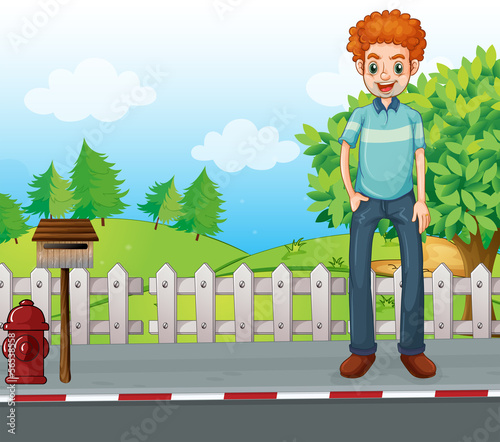 A smiling man standing near the wooden mailbox