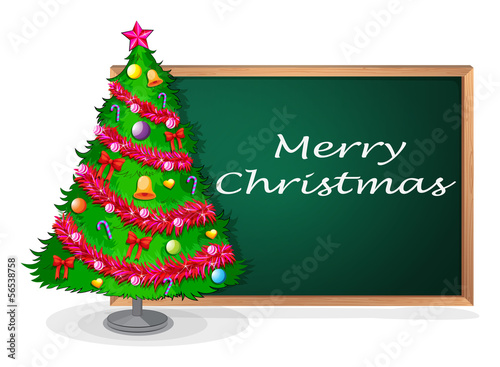 A blackboard at the back of a christmas tree