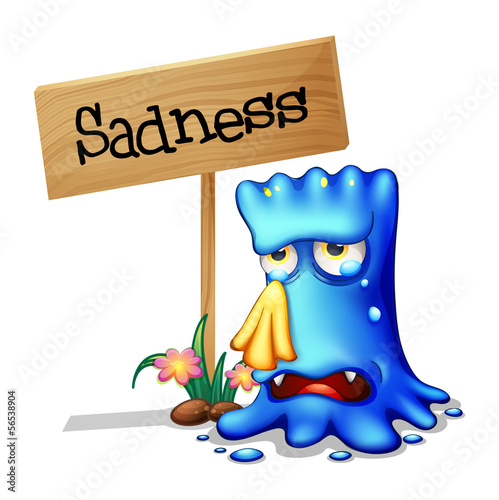 A very sad blue monster crying near a wooden signage