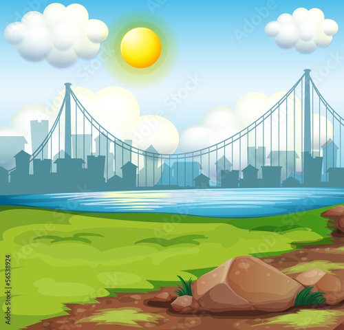 A view of the river near the tall buildings under the bright sun