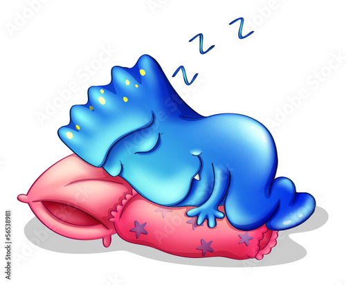 A blue monster sleeping above a pillow