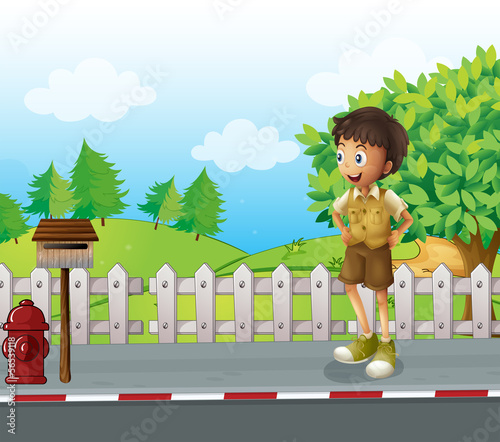 A boy at the road near the wooden mailbox