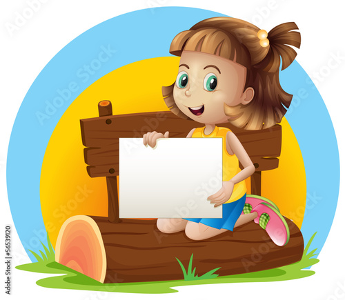 A girl above a log holding an empty signage
