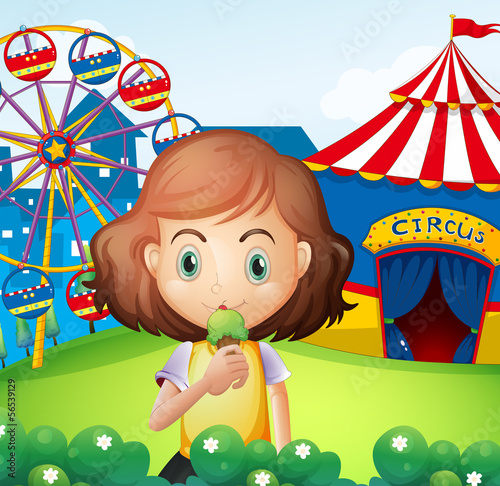 A girl at the carnival eating an icecream