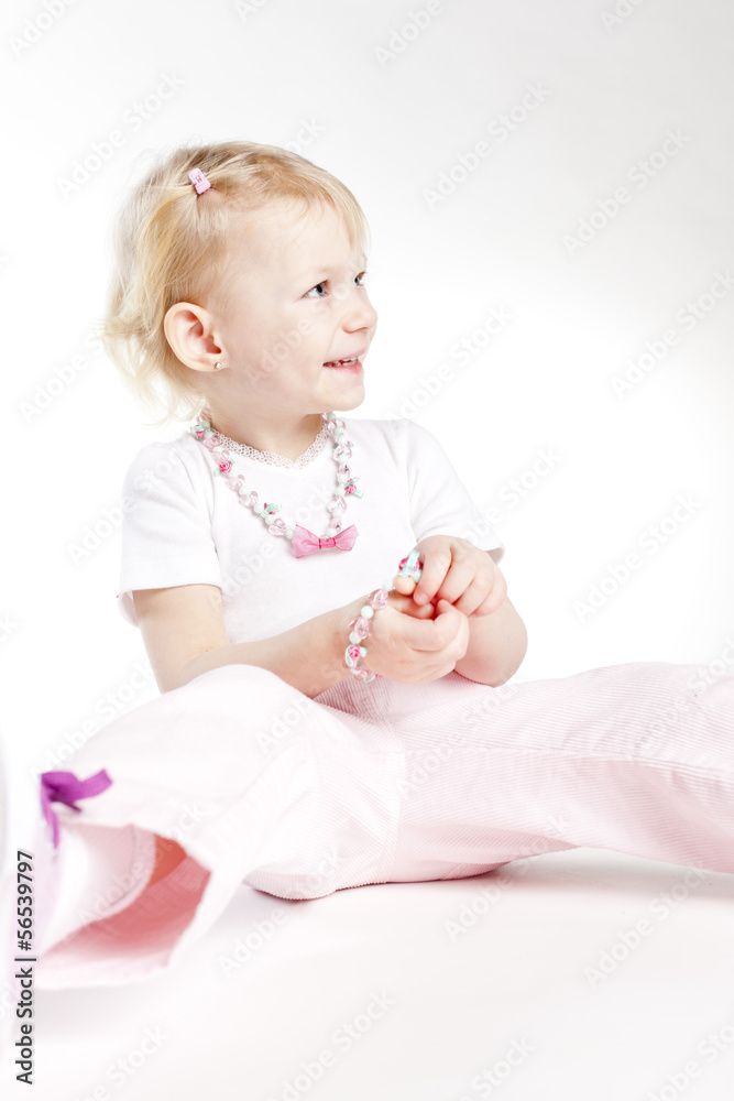 portrait of sitting little girl wearing necklace portrait of sitting little girl wearing necklace