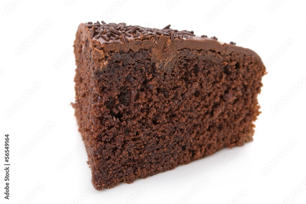 Slice of chocolate fudge cake with sprinkles detail on white.