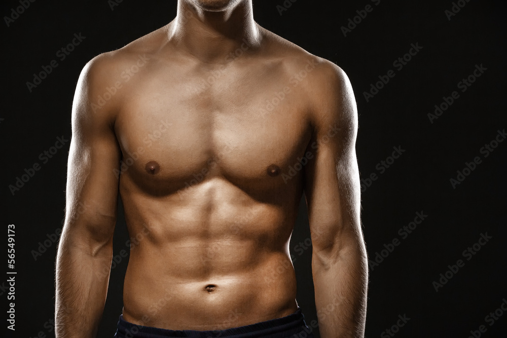 Close up of naked male's body, isolated on black Close up of naked male's body, isolated on black