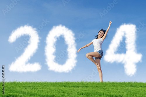 Beautiful dancer woman with 2014 New Year clouds