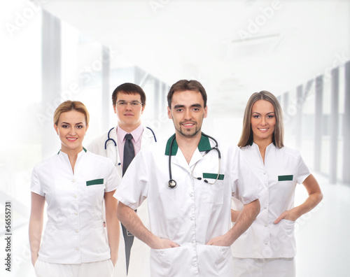 A team of doctors standing in white clothes in the hospital