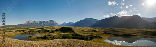 A panorama view of country farm field with mountain background