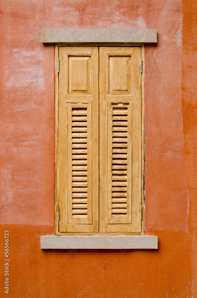 wood window on orange wall