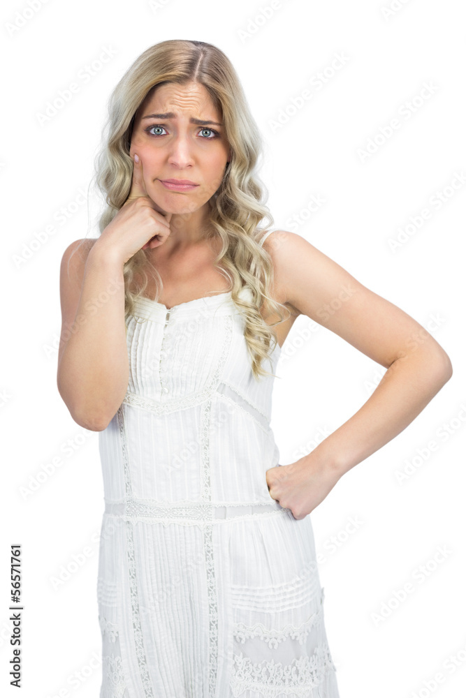 Doubtful curly haired blonde having interrogative posture Doubtful curly haired blonde having interrogative posture