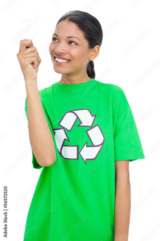Cheerful model wearing recycling tshirt holding light bulb Cheerful model wearing recycling tshirt holding light bulb