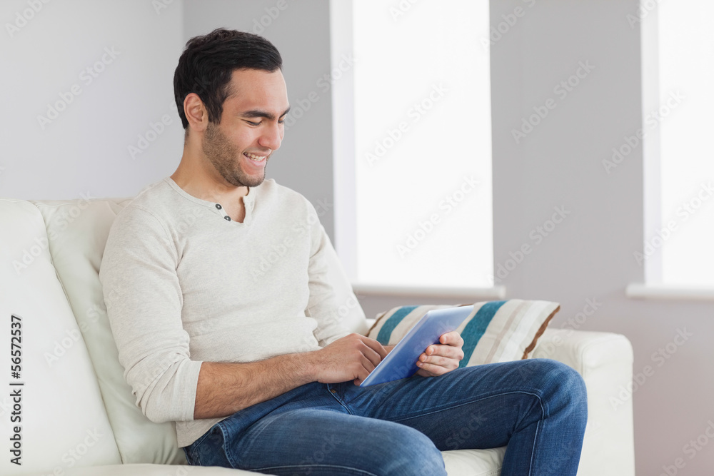 Happy casual man using his tablet Happy casual man using his tablet