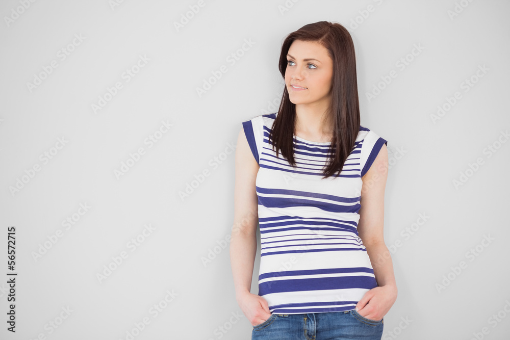 Thoughtful stylish girl standing and looking away