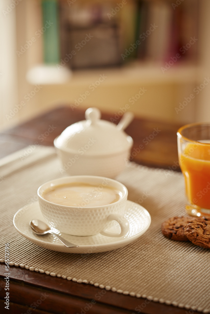 Breakfast table with juice, coffe and cookies