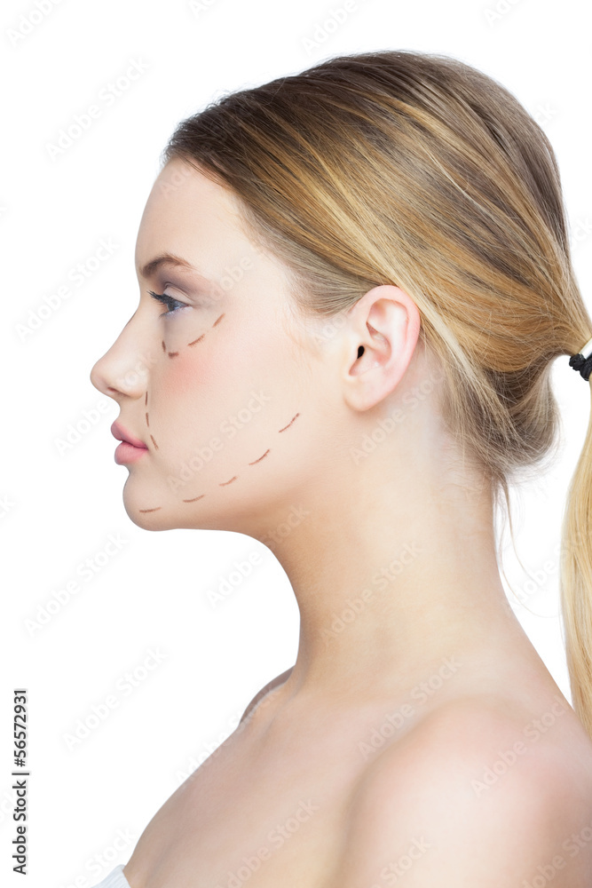 Profile view of calm pretty blonde with dotted lines on the face Profile view of calm pretty blonde with dotted lines on the face