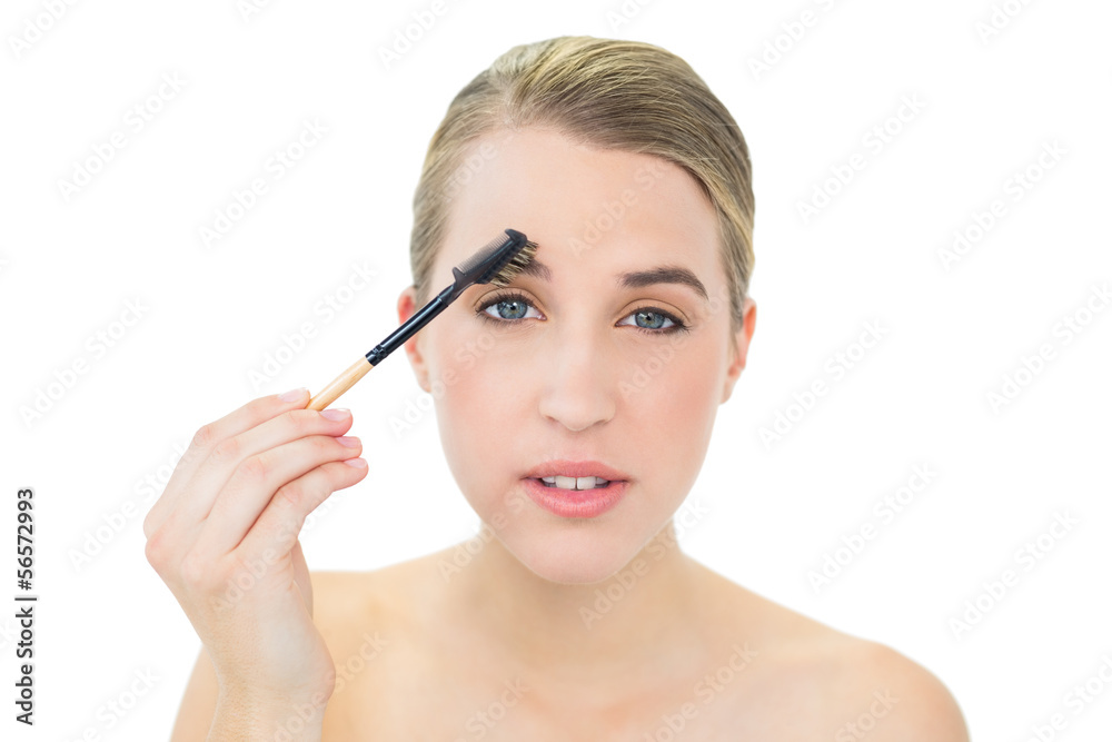 Attractive blonde using eyebrow brush Attractive blonde using eyebrow brush