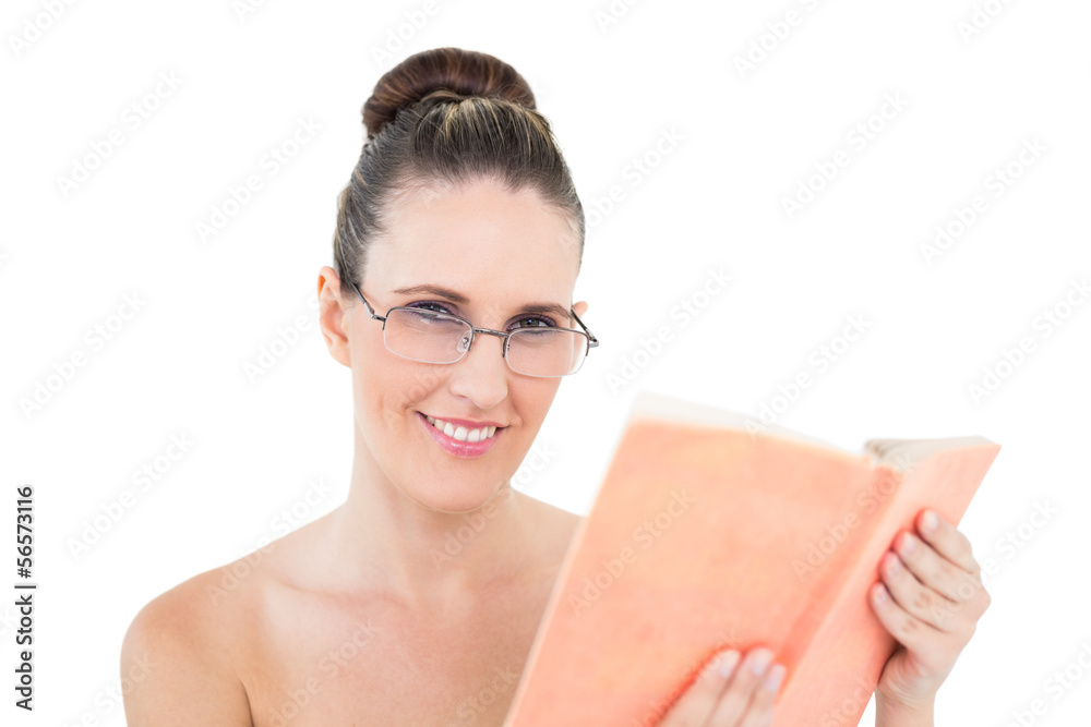 Woman with glasses holding book looking at camera Woman with glasses holding book looking at camera
