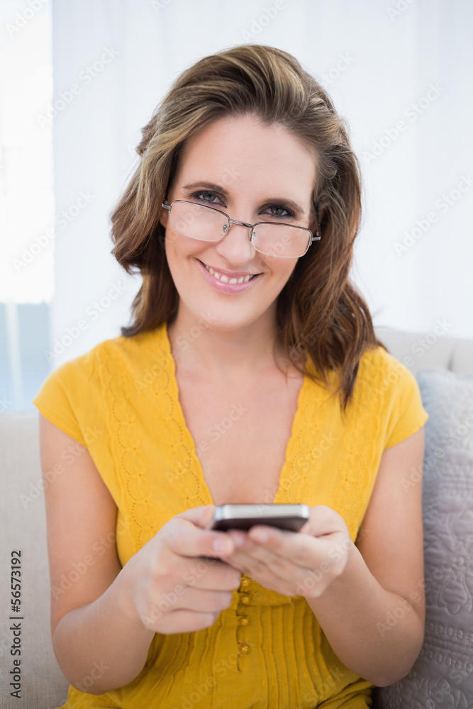 Happy woman with glasses holding phone Happy woman with glasses holding phone