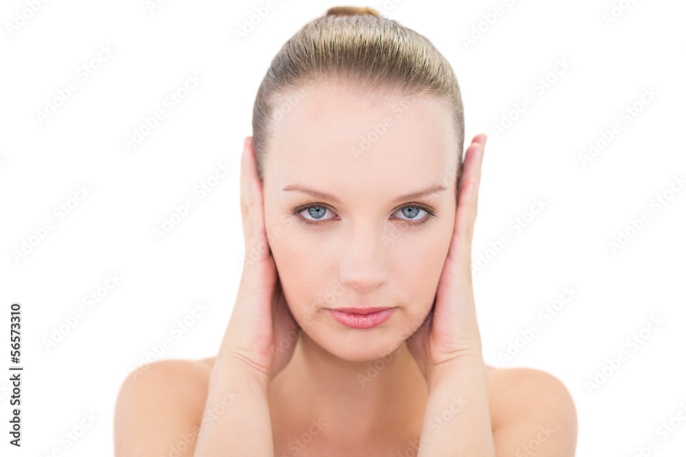 Stressed pretty blonde model blocking her ears Stressed pretty blonde model blocking her ears