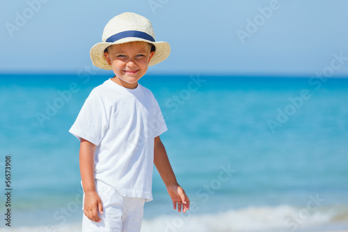 Boy with hat on the beach