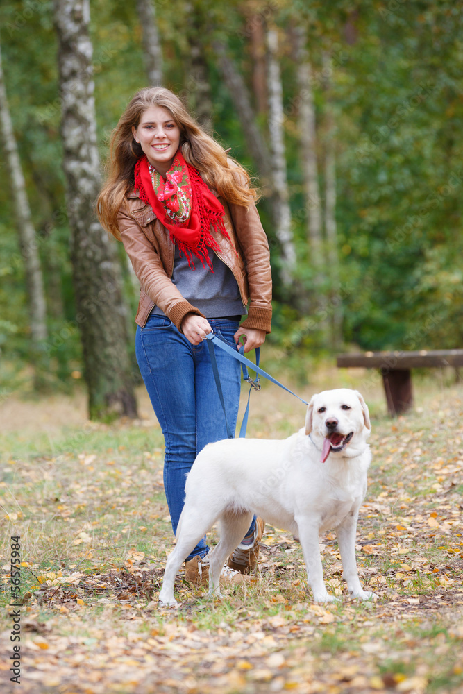 Beautiful woman walking with her dog in the forest Beautiful woman walking with her dog in the forest