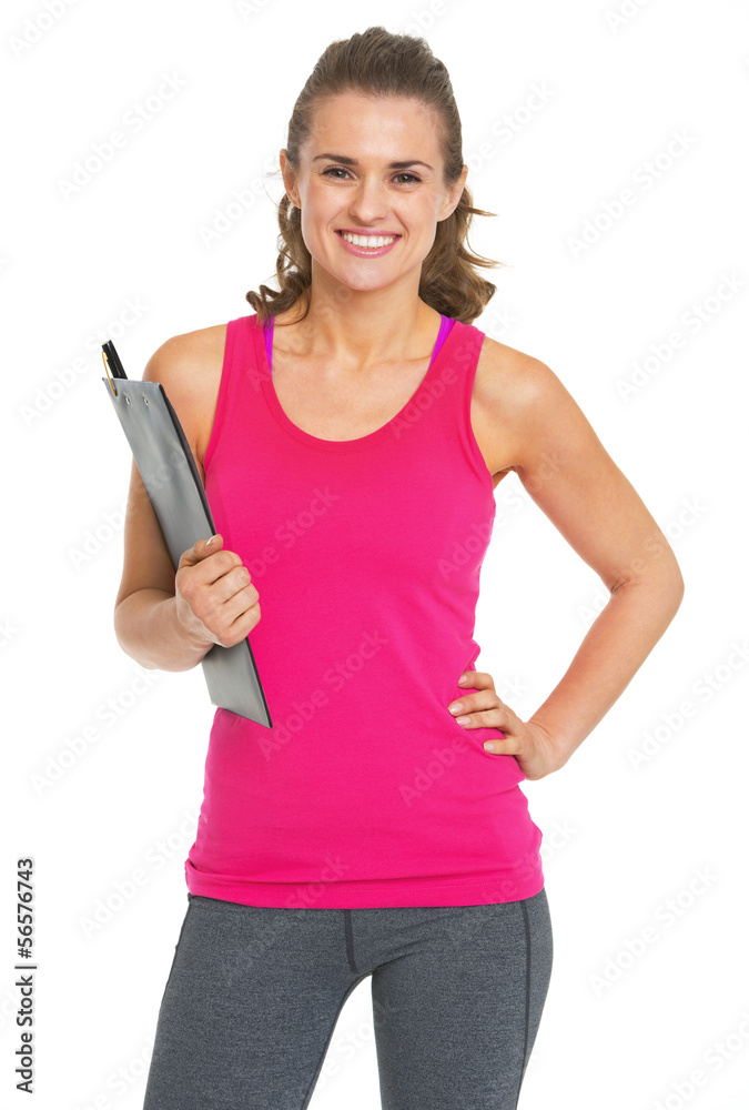 Smiling fitness trainer with clipboard Smiling fitness trainer with clipboard