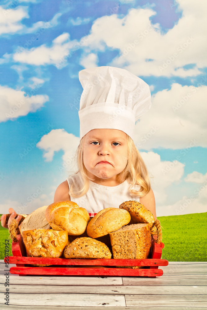 Little girl in chef hat cook healthy soup in a big pot, and prep Little girl in chef hat cook healthy soup in a big pot, and prep