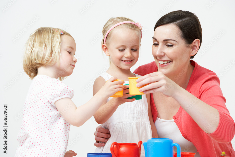 Pre School Children Enjoying Tea Party With Teacher Pre School Children Enjoying Tea Party With Teacher