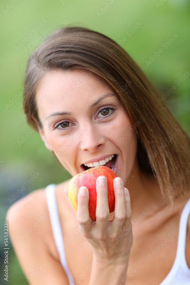 Beautiful girl eating red apple Beautiful girl eating red apple