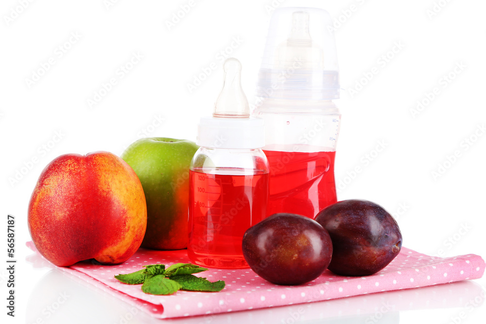 Fruits and baby bottles with compote on napkin isolated on Fruits and baby bottles with compote on napkin isolated on