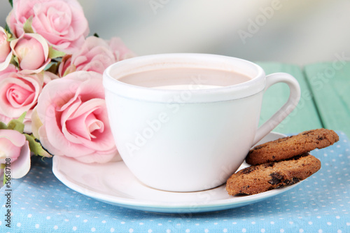 Cocoa drink  and cookies on wooden  table, on bright background