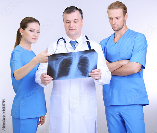 Medical workers on grey bac...