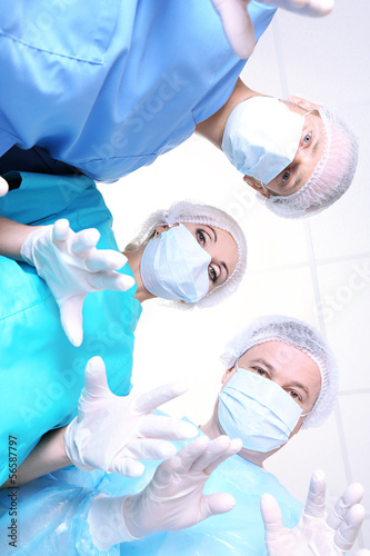 View from below of surgeons in protective work wear during