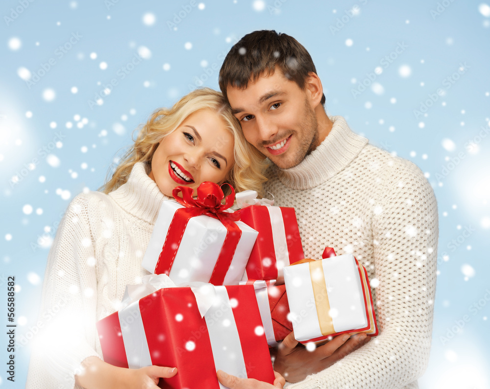 happy man and woman with many gift boxes happy man and woman with many gift boxes