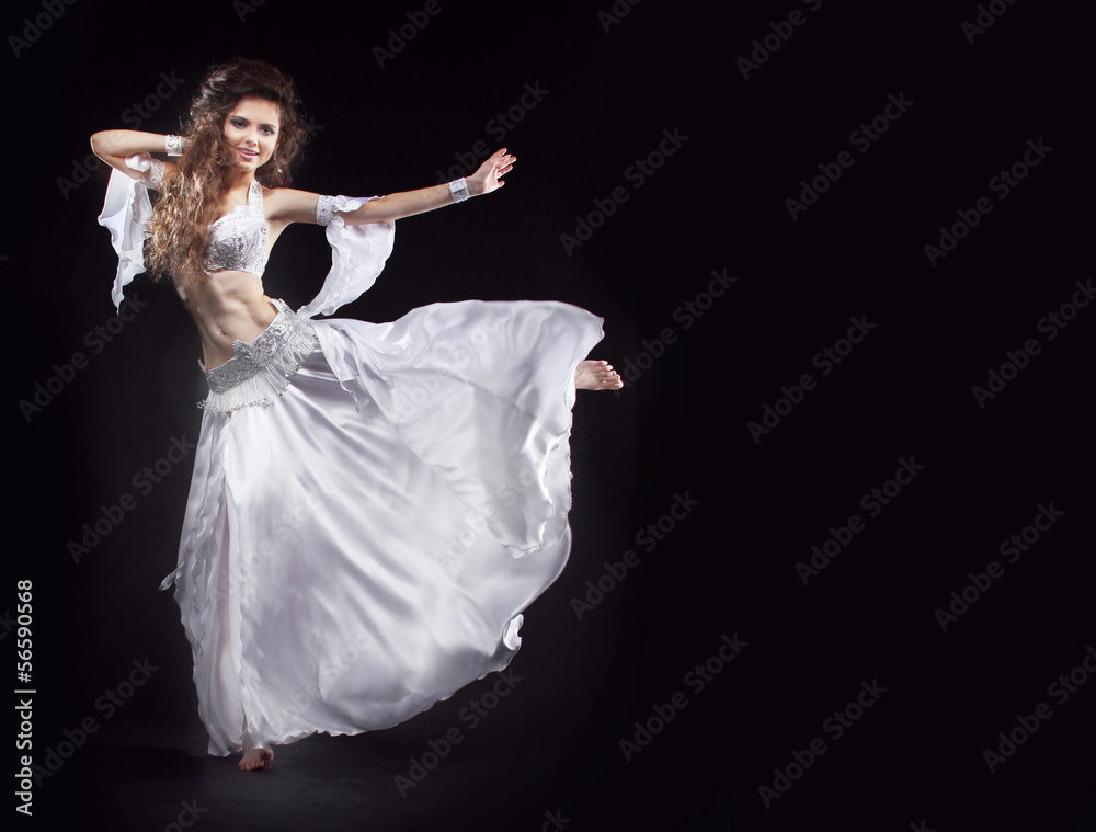 Naklejka premium Beauty Girl belly dancer in white suit oriental dance in motion
