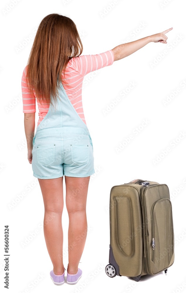Back view of traveling pointing woman with suitcase Back view of traveling pointing woman with suitcase
