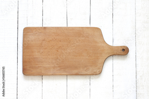 Empty cutting board on white planks food background concept