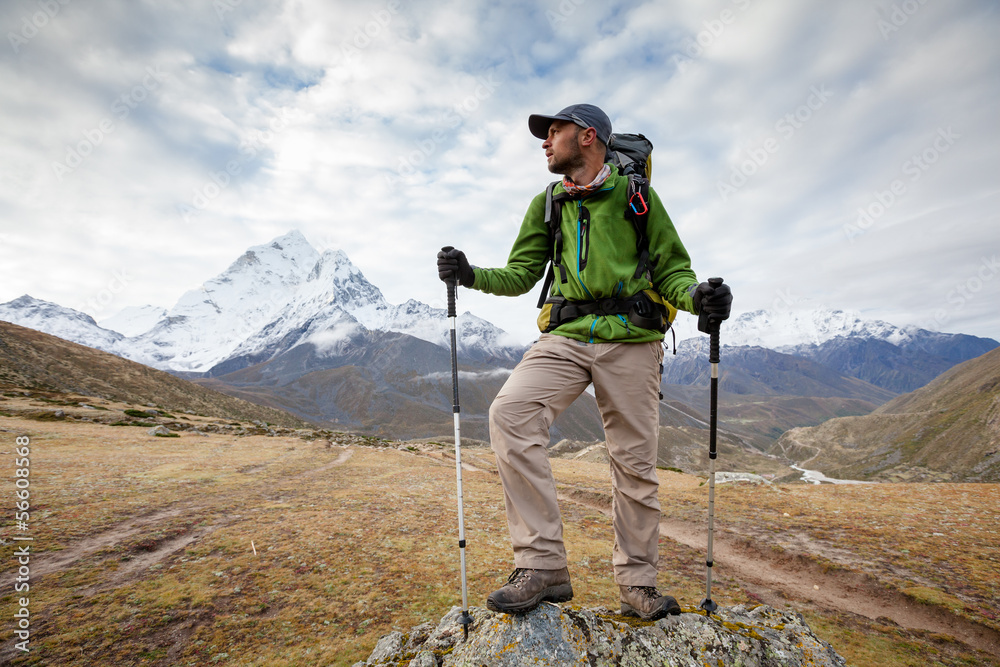 Hiker posing at camera on the trek in Himalayas, Nepal