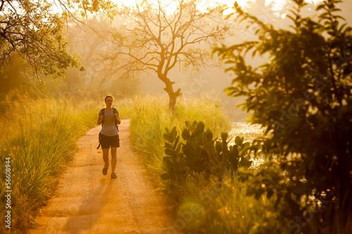 Woman has walk at the lakeside during sunrise