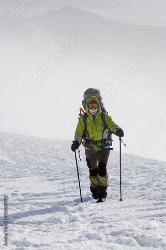 Hiker walking in winter Carpathian mountains