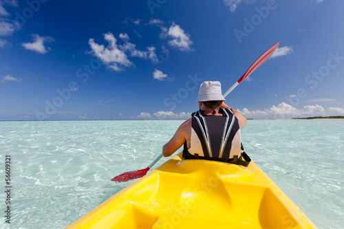 Caucasian man kayaking in sea at Maldives