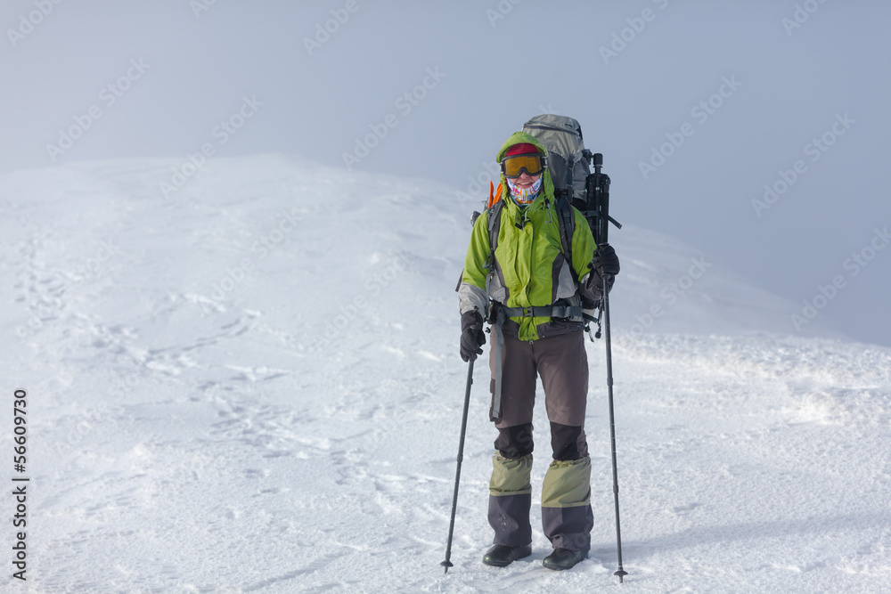 Hiker posing at camera in winter mountains Hiker posing at camera in winter mountains